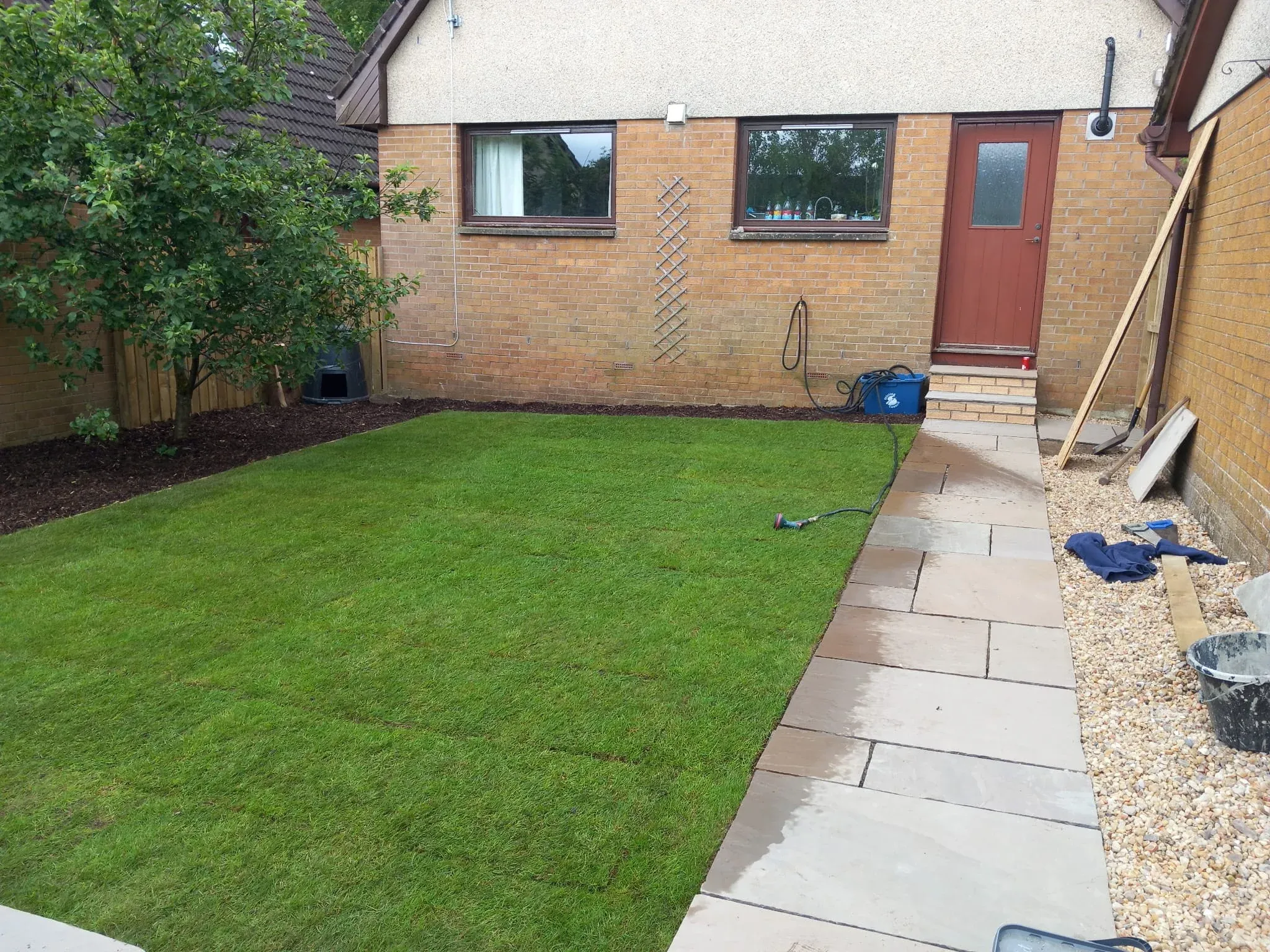 New turf lawn with a sandstone pathway laid in Stirling