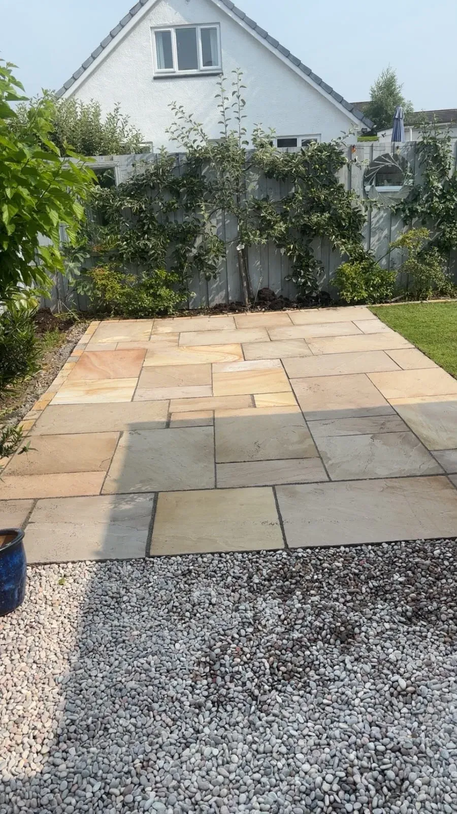 Completed Indian sandstone patio in a transformed rear garden in Stirling