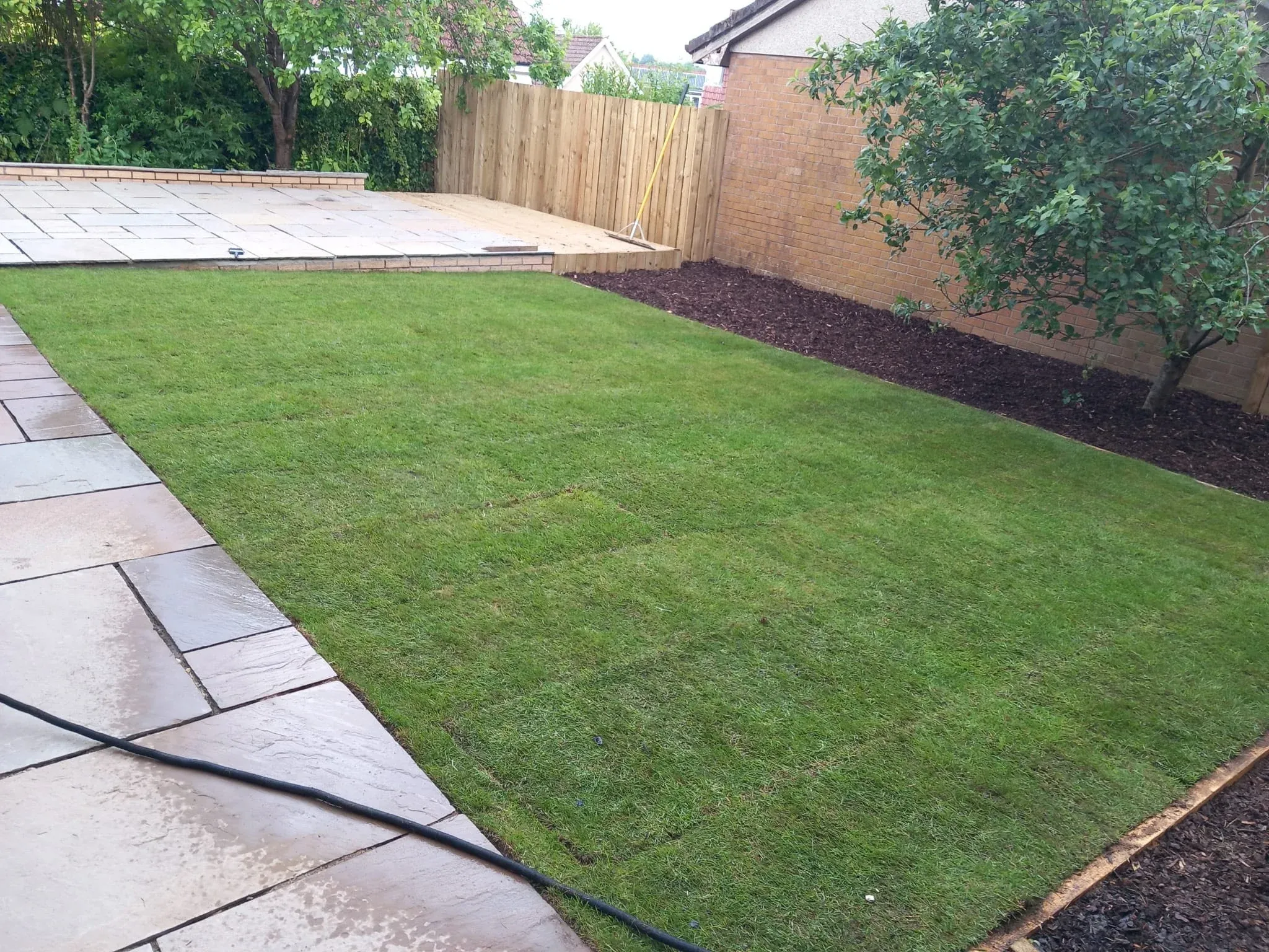 New turf lawn laid to a patio edge in Stirling